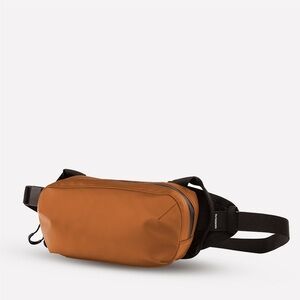 WANDRD Men's orange D1 fanny pack / Belt Bag with Adjustable Black Strap